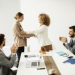 women-shaking-hands-in-a-meeting-photo